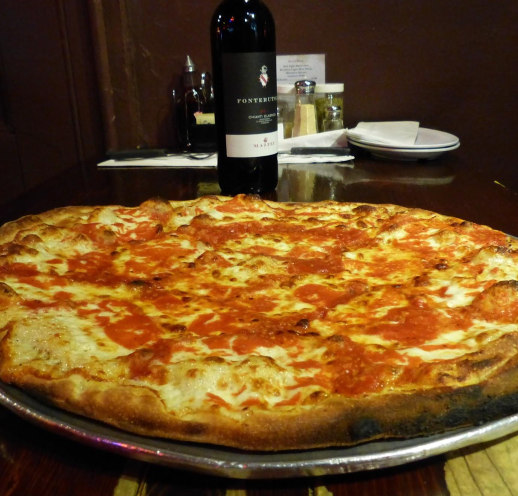 a pizza sitting on top of a pan on a table