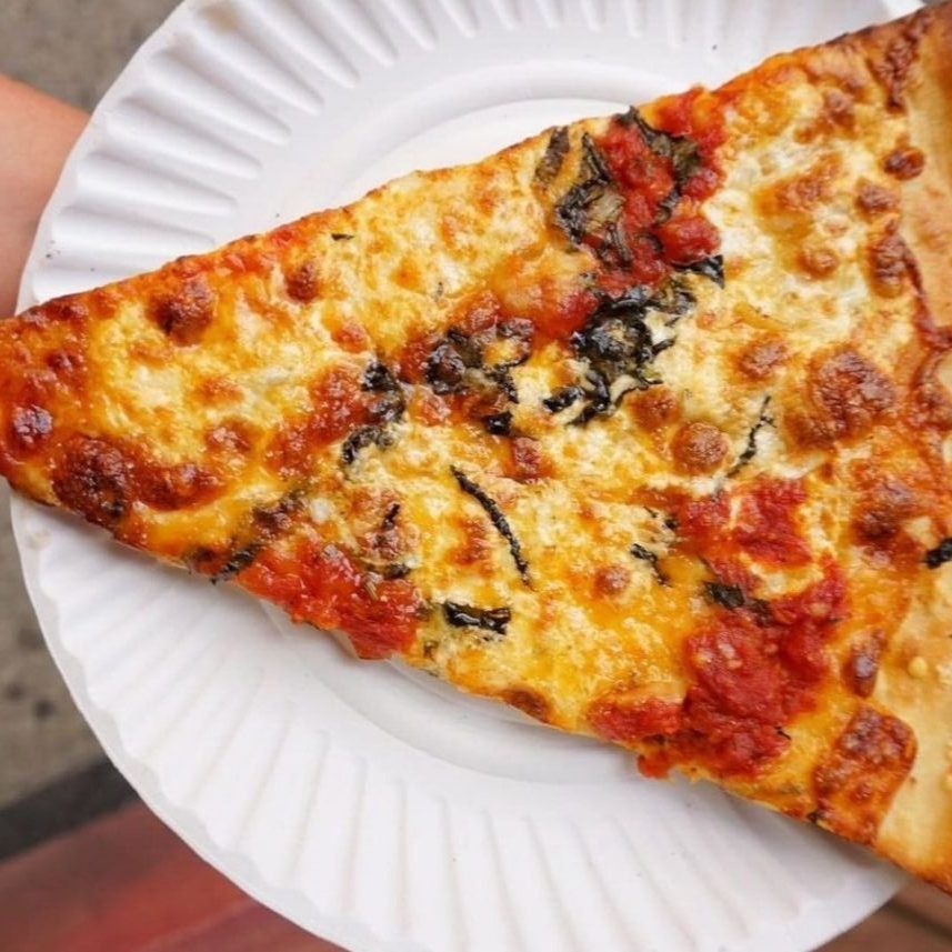 a slice of pizza on a paper plate