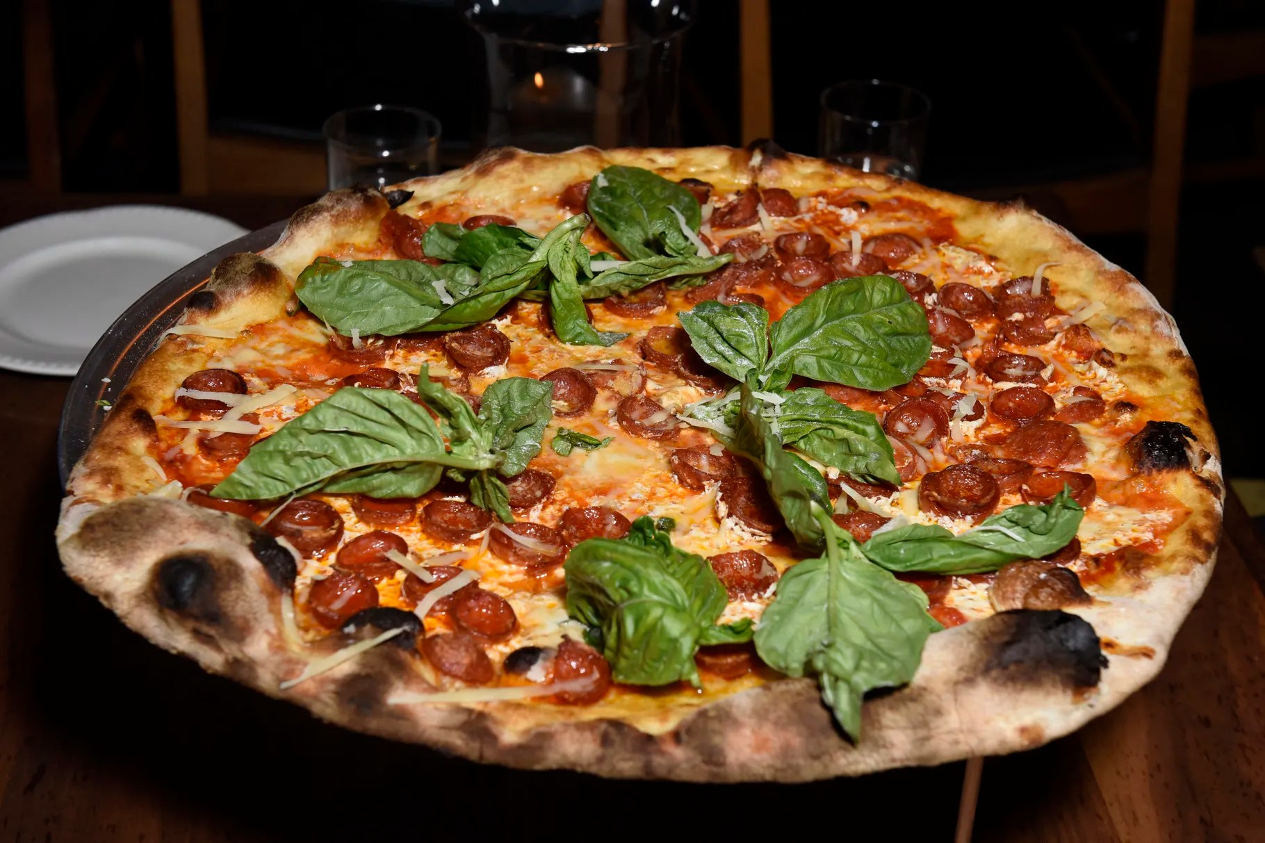 a pizza sitting on top of a wooden table